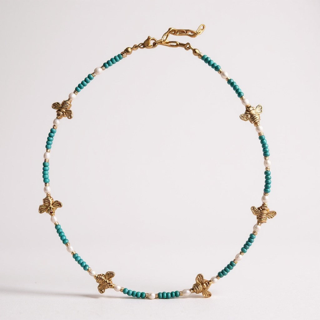 Turquoise bead and freshwater pearl necklace with gold-plated bee charms
