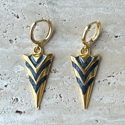 Gold arrowhead hoop earrings with black enamel chevron design