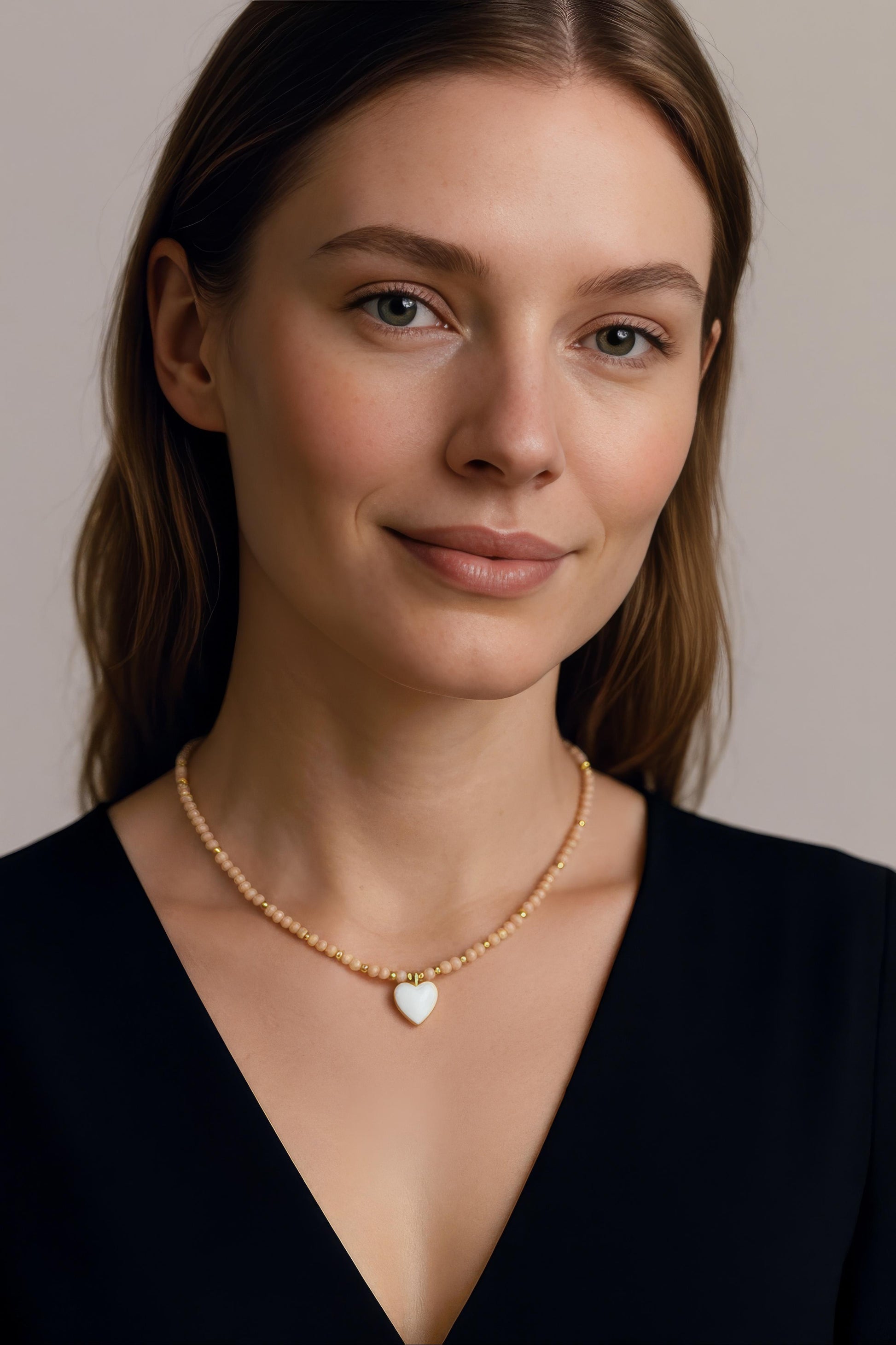 Nude-peach crystal necklace with gold-plated heart charm