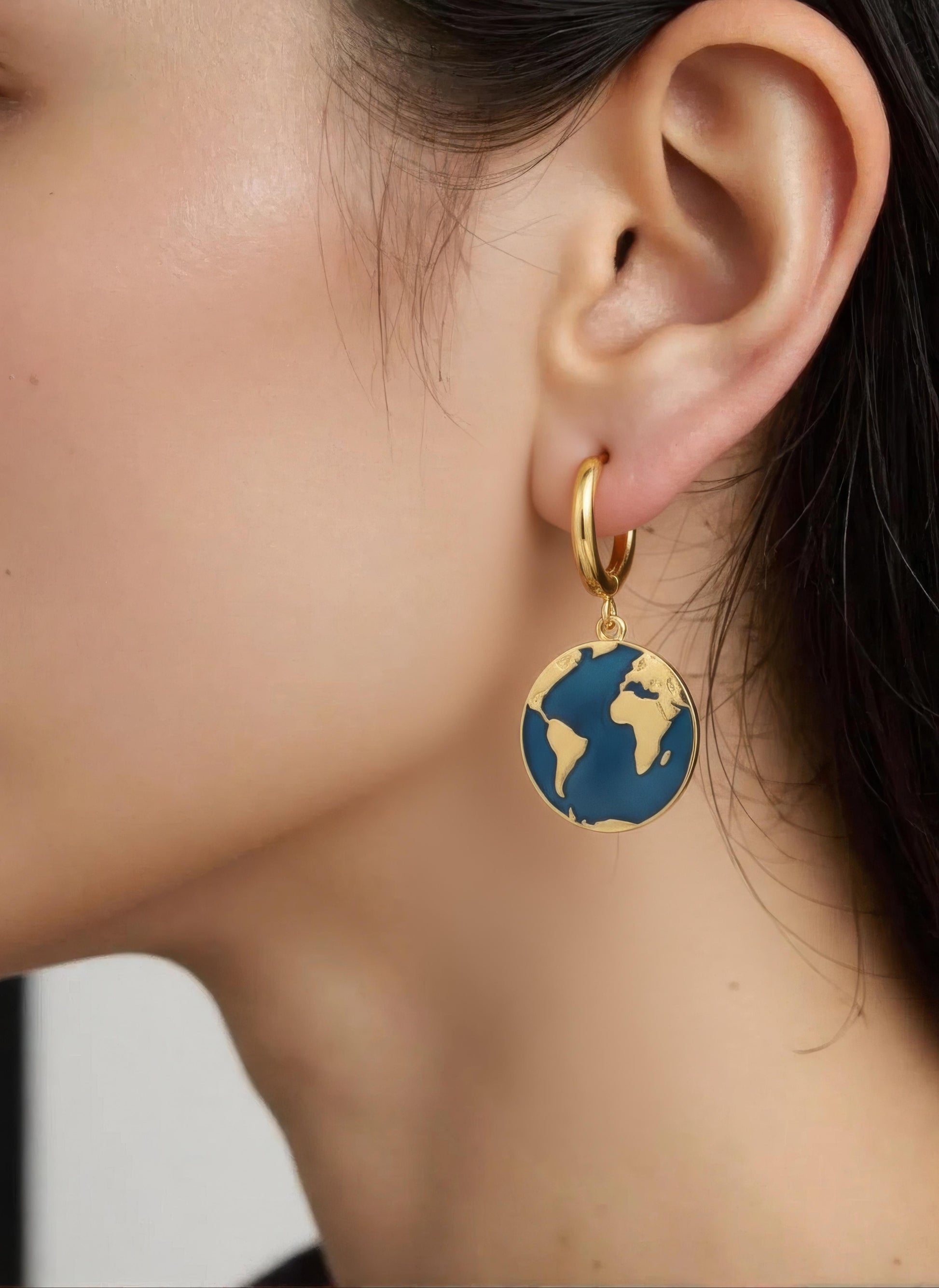 Gold-plated hoop earrings with navy enamel globe charm