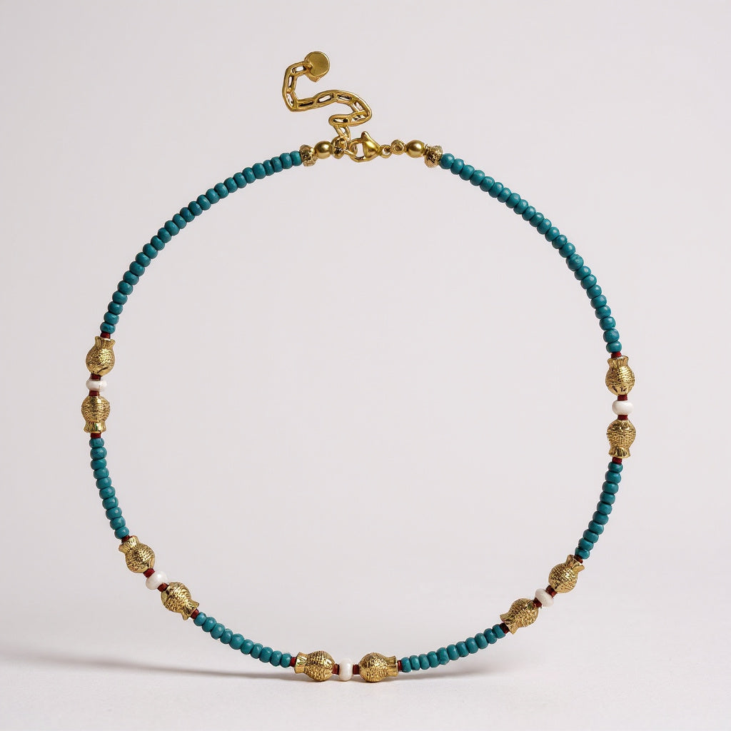 Turquoise and freshwater pearl necklace with gold-plated fish charms and red coral accents