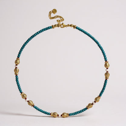 Turquoise and freshwater pearl necklace with gold-plated fish charms and red coral accents