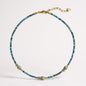Apatite beaded necklace with three gold-plated mother-of-pearl fish charms
