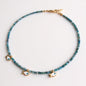 Apatite necklace with three gold-plated fish charms and eye motif