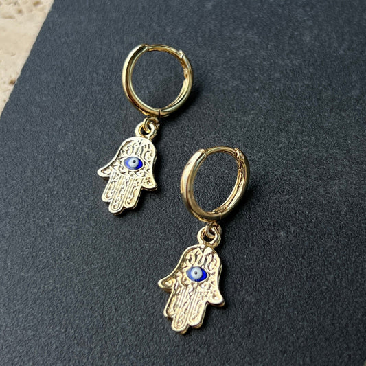 Gold Hamsa hand hoop earrings with blue enamel evil eye charm