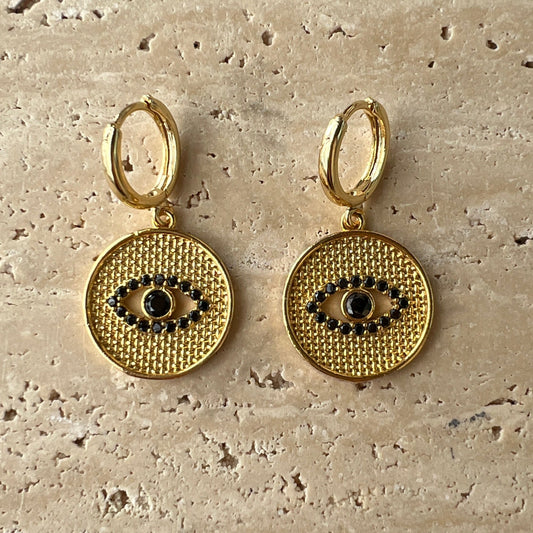 Gold hoop earrings with textured medallion and black zirconia evil eye