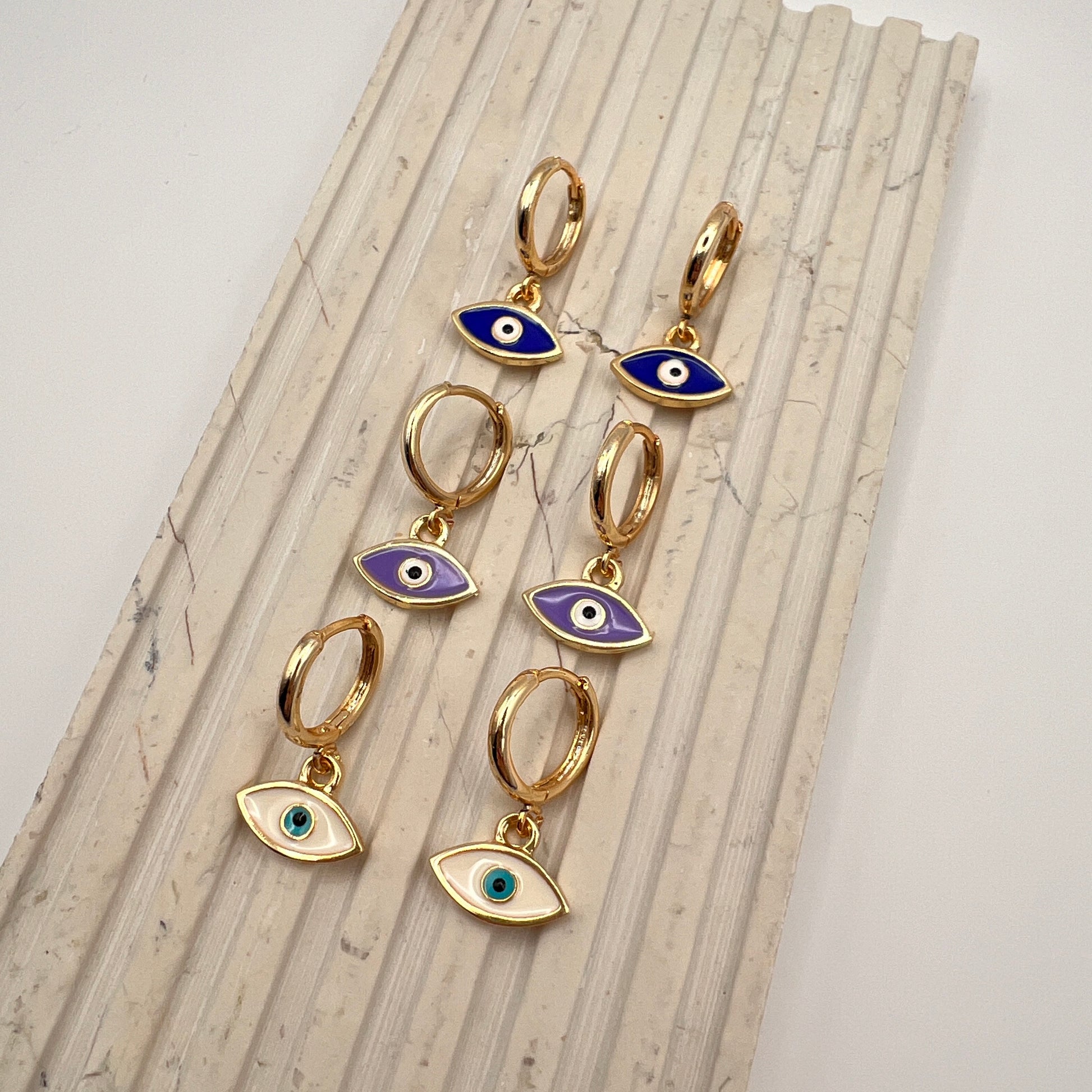 Gold-plated hoop earrings with white enamel evil eye charm