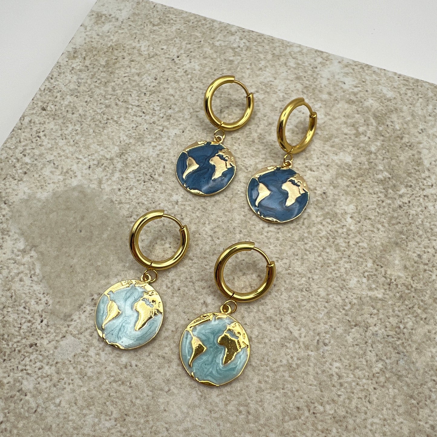 Gold-plated hoop earrings with turquoise enamel globe charm