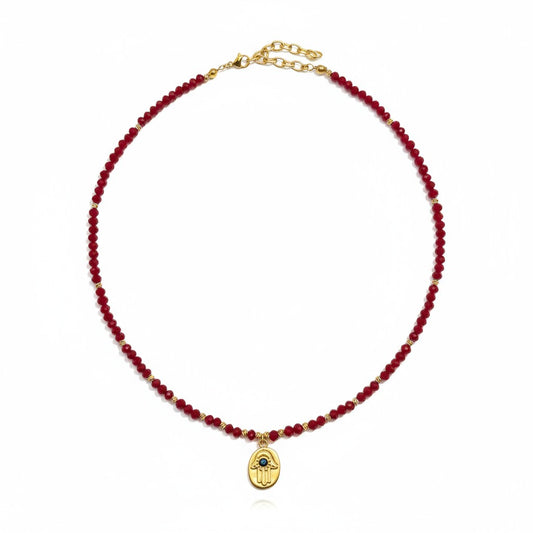 Red crystal necklace with gold-plated Hamsa charm and evil eye detailing