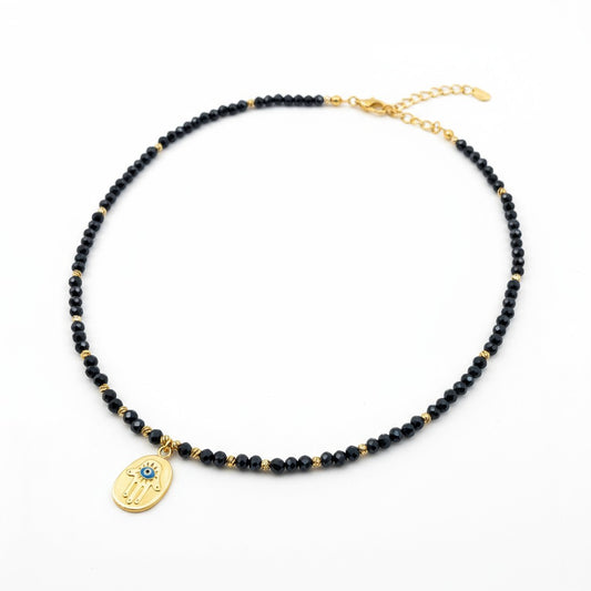 Navy crystal necklace with gold-plated Hamsa charm and blue evil eye accent