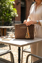 Handcrafted Porto Terra Bag in chocolate brown with straw tassel charm