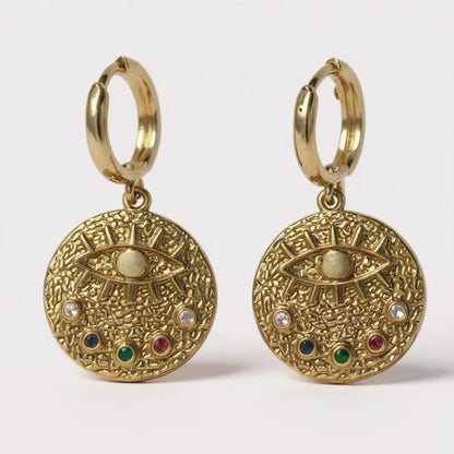 Gold hoop earrings with textured medallion, evil eye, and multicolor stones